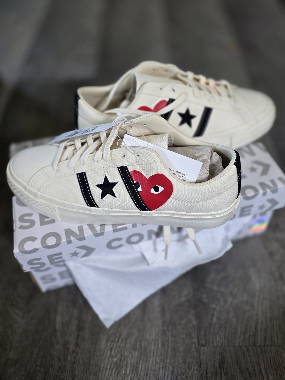 the Comme des Garçons PLAY x Converse One Star Academy Pro "Milk" sneakers, feat
